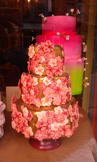 Gold cake with pink poppy decoration